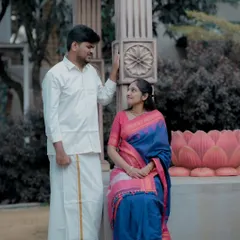 A romantic moment captured between a couple dressed in traditional outfits. The setting, with its carved pillars and lotus-themed architecture, adds a touch of cultural richness.