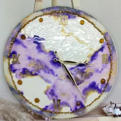 A close-up of the finished resin clock, highlighting the beautiful flow of purple and gold pigments and the glossy, professional finish achieved in our classes.