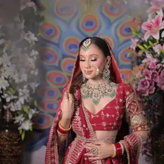 The bride's portrait with eyes gently closed, highlighting the detailed eye makeup and heavy bridal jewelry set.