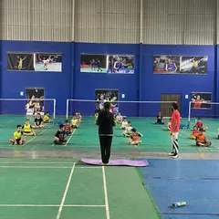 A full-group view of a guided yoga session on the courts. We believe in a holistic approach to training, combining on-court skill with off-court physical and mental conditioning.