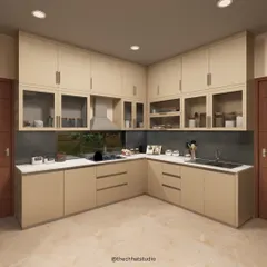 This L-shaped kitchen is designed for maximum efficiency and style. The light wood cabinets, some with frosted glass fronts, provide ample storage, while the large window over the sink offers a pleasant view and natural light.