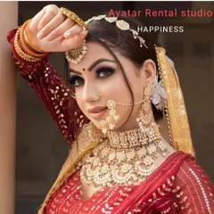 A beautiful close-up of a bride in a red lehenga, showcasing the flawless makeup and a complete gold jewellery set, all from my studio.