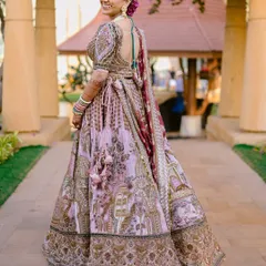 A beautiful back shot showcasing the bride's elegant hairstyle and the intricate details of her blouse and lehenga.