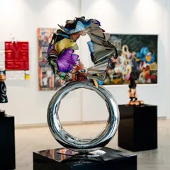 "Flight to Infinity" is a sculpture that blends polished metal and vibrant butterfly motifs. The circular base symbolizes unity and infinity, while the butterflies represent movement, transformation, and life.