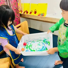 Collaboration is at the heart of our activities. In this marble painting project, two children work together, learning to coordinate and communicate while creating something beautiful. This is a great example of our focus on social skills enrichment through play.