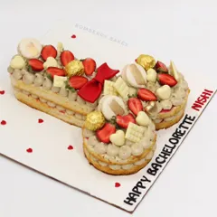 Another angle of the bachelorette tart cake, showing the fun shape and delicious toppings.