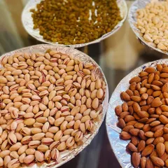 An assortment of premium dry fruits including pistachios, almonds, cashews, and raisins. This is an excellent option for a 'Baarath Swagath' (welcoming the groom's procession) or as a healthy snack counter.