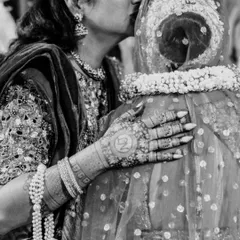 A mother's kiss for her daughter on her wedding day. A timeless, emotional black and white photograph capturing a lifetime of love in a single gesture.