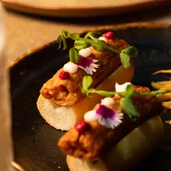 The details are what make a dish memorable. Here you can see the delicate placement of edible flowers and microgreens, adding a touch of artistry to the plate.