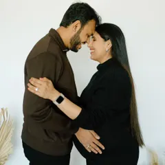 Forehead kisses and the promise of a new beginning. This intimate studio portrait captures the deep bond and anticipation of parenthood.