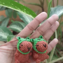 A close-up of my matching capybara keychains, complete with little froggy hats. These are perfect for sharing with a friend or just keeping as a cute companion for your keys.
