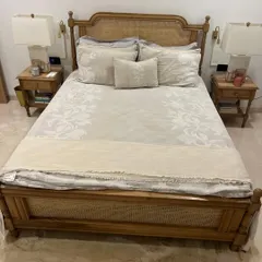 This French-style bed was a custom piece I made for a Bollywood actor. It's crafted from solid oak wood and features beautiful cane panels on the headboard and footboard, along with matching two-tier nightstands.