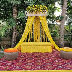 A classic 'Dulhaniya' Haldi setup for the bride. This design features a comfortable seating area framed by beautiful marigold curtains and traditional matkas.