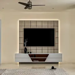 A minimalist floating TV console in white and wood. The design is complemented by a tiled back panel and subtle backlighting, creating a clean and sophisticated focal point in the living room.