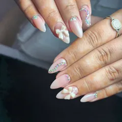Perfect for weddings, engagements, or any special occasion, this design combines elegance with a touch of glamour. It features a soft nude acrylic base, delicate 3D sculpted bows, and carefully placed iridescent crystal accents.