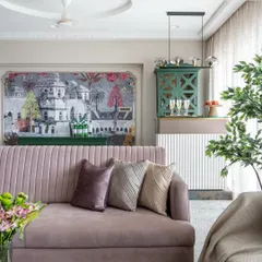 This living room is a celebration of color and pattern. The mauve sofa provides a soft, inviting base, while the striking wallpaper and green bar cabinet add layers of personality and a touch of eclectic charm.
