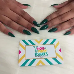 This deep, forest green color is stunning and unique. A solid color manicure like this on sharp stiletto nails makes a powerful and fashionable statement.