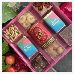 This is my Bomb Tray, a truly grand gesture for Diwali gifting. It is loaded with a curated selection of gourmet treats like brownie bites, mini chocolate chip cookies, peri peri almonds, and other festive sweets, all arranged beautifully on a reusable tray.
