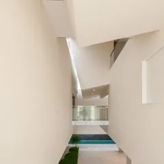 the resulting interior volume… a tall, narrow space within the neeti residence, drawing light down from skylights.