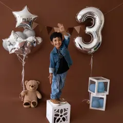 This cool dude is turning three! A fun and stylish birthday shoot with a denim theme, complete with balloons and a teddy bear companion.