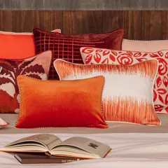 A lavish assortment of our artisanal cushions, each a masterpiece of texture and colour. This collection features vibrant ombre velvets, intricate embroidery, and bold graphic prints, demonstrating how we use these essential accents to layer personality and luxurious comfort into any interior scheme.