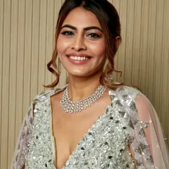 You can never have too much shimmer. This client is glowing in a full-glam look with silver glitter eyeshadow, radiant skin, and a chic ponytail for her reception.