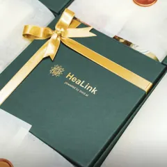 A custom branded gift box for HeaLink. The deep green box paired with a gold ribbon and logo creates a premium feel, perfect for high value client gifting or special corporate events.