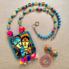 The complete Radha Krishna hand-painted jewellery set, laid out to display the harmony between the necklace and the matching wooden jhumka earrings.