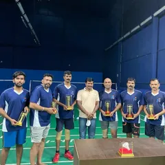 A group of winners from our adult league, each holding their individual trophies.