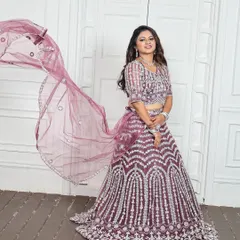 The sheer dupatta with its embellished border adds a layer of grace without hiding the detailed work on the blouse. This rental lehenga is designed for both style and comfort.