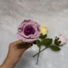 A close-up of a single dual-color rose, highlighting the layered petals that give it a realistic, blooming appearance.