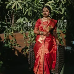 The full look, showcasing the beautiful red Kanjivaram and temple jewellery. The makeup is designed to balance the richness of the attire, creating a harmonious and elegant appearance.