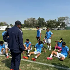 A coach's job is to see the potential in every player. Here, our coach observes a drill, ensuring every player understands their role and is pushing their limits.