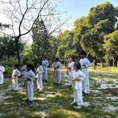 Young karate students practicing their stances during an outdoor training session. Discipline and focus are built both inside and outside the dojo.