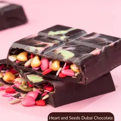 A close-up of the Heart and Seeds Dubai Chocolate Bar. This viral treat is filled with colorful seeds, offering a unique and crunchy texture.