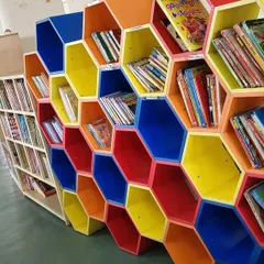 This colourful, honeycomb-style bookshelf at a school library is so inviting. Creative spaces like this make reading even more exciting for children.