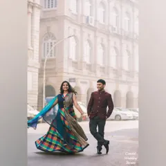 A beautiful shot of the bride-to-be twirling in a colourful lehenga on a misty Mumbai street, creating a sense of movement and joy.