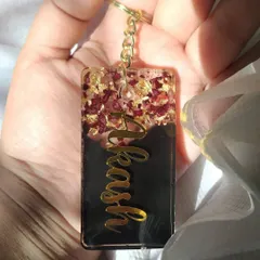 Here is another look at the personalized name keychain with preserved rose petals. The contrast between the dark background and the gold lettering makes the name stand out beautifully.