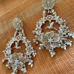 My take on the classic Chandbali, handcrafted in 18k yellow gold. These earrings feature intricate lace like patterns with birds, diamonds, and pearls, perfect for celebrating new beginnings.