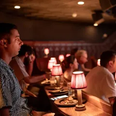 A guest completely engrossed in the film at our Ratatouille screening. The warm, focused lighting and intimate seating at The Piano Man allow for a truly immersive experience where you can lose yourself in the story.