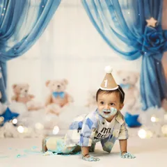 Even with cake on his face, he's on the move! This crawling shot shows his playful energy during the cake smash. We love capturing these action shots that show your baby's personality.