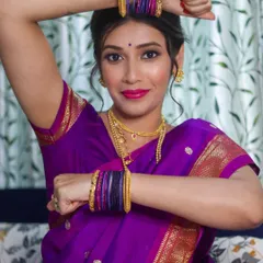 A playful and elegant pose from a Maharashtrian bride, showing off her colorful bangles and the flawless makeup look I created for her special day.