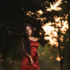 An outdoor portrait session where the sunset, the location, and the red dress came together perfectly. I used the trees to create a beautiful, blurry bokeh effect that makes the subject stand out.