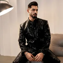 For your cocktail nights and sangeets, we created this fully sequined black Indo-Western jacket. The sharp tailoring and shimmering texture make it a definitive statement piece, designed to catch the light and command attention.