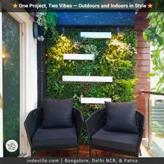This balcony corner is a mini-escape. I installed a lush artificial vertical garden as a backdrop for the sleek black lounge chairs, creating a modern and stylish outdoor seating area with a strong connection to nature.