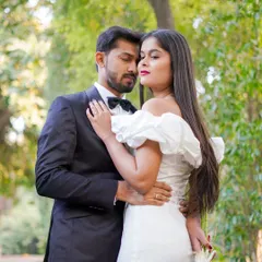 An intimate embrace in a beautiful garden setting. The soft focus on the background foliage draws all the attention to the couple's connection.