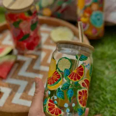 Sip in style this summer with my hand-painted glass sipper jars. This one is covered in a zesty citrus fruit design, perfect for your favorite cold drinks.