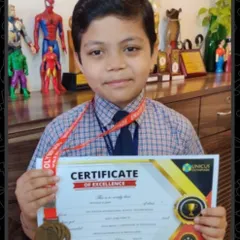 A close-up of my student Reyansh, proudly holding his Certificate of Excellence and medal. His success in the Mental Math World Cup is an inspiration to all the makkalu at my center.