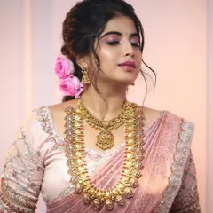 A modern South Indian bridal look featuring our layered temple jewellery. The short necklace with a Lakshmi pendant and the longer kasu malai (coin necklace) create a full, opulent look.