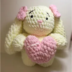 My large plushie bunny, shown here holding a soft pink heart, is made with extra-fluffy yarn for a super soft and squishy feel.